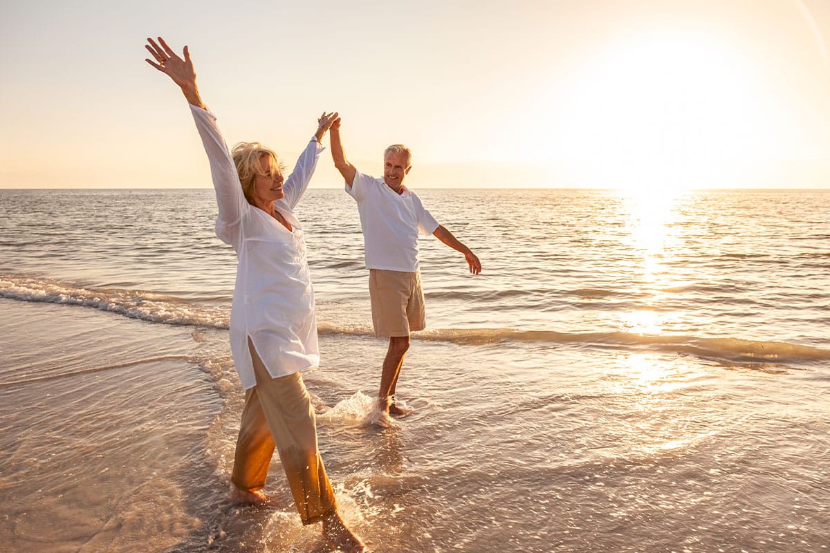 older couple on the beach after sermorelin therapy in Virginia Beach
