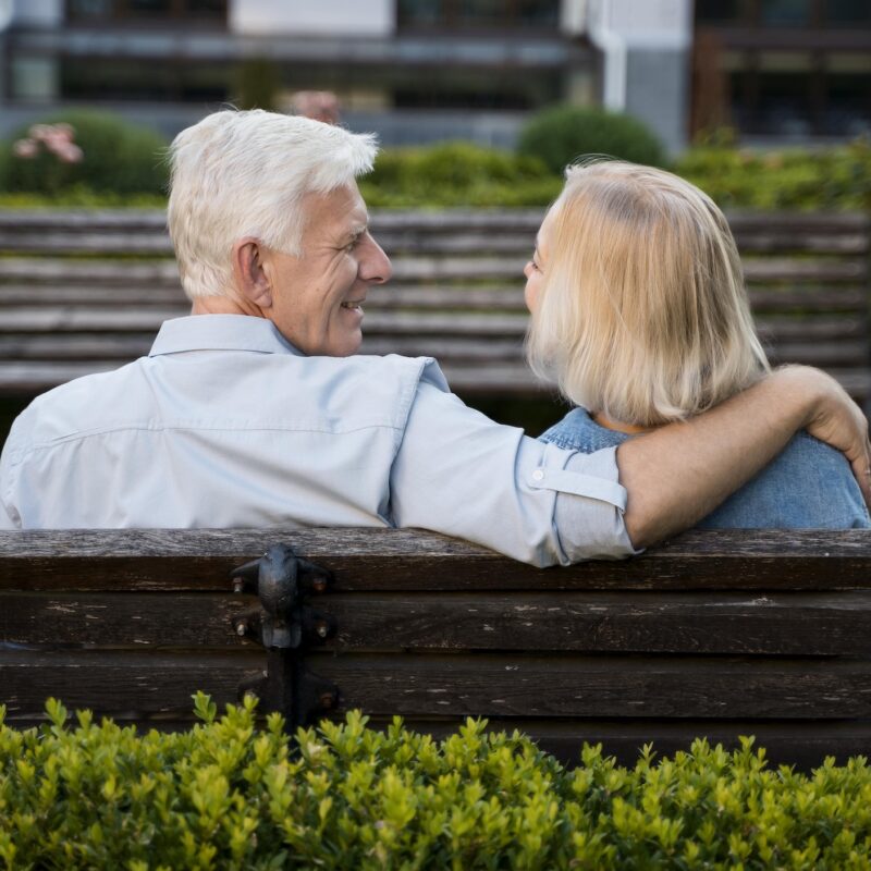 man and woman together on a park bench