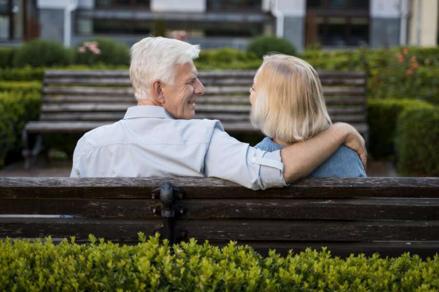 man and woman together on a park bench