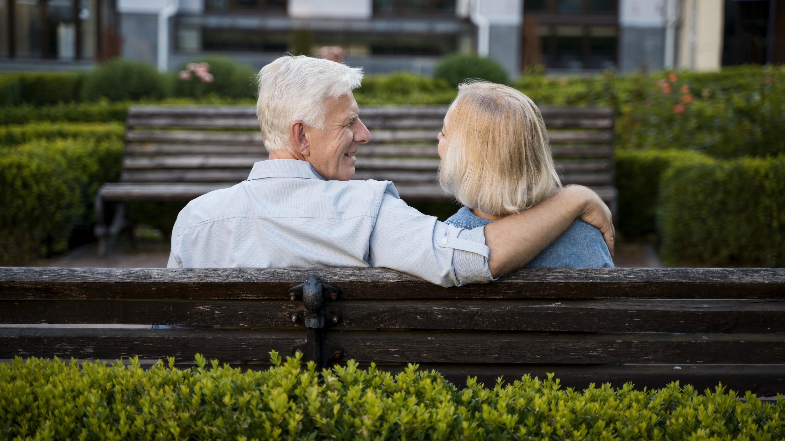man and woman together on a park bench