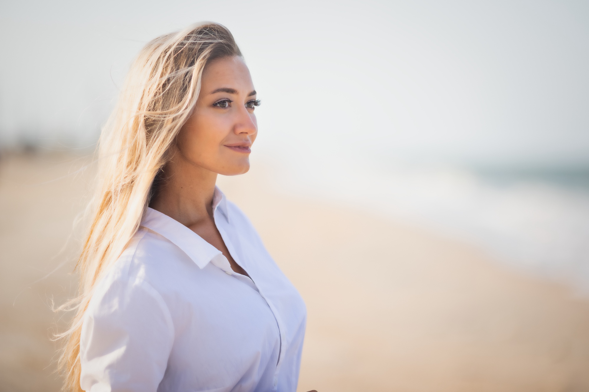 woman with blond hair overlooking the ocean