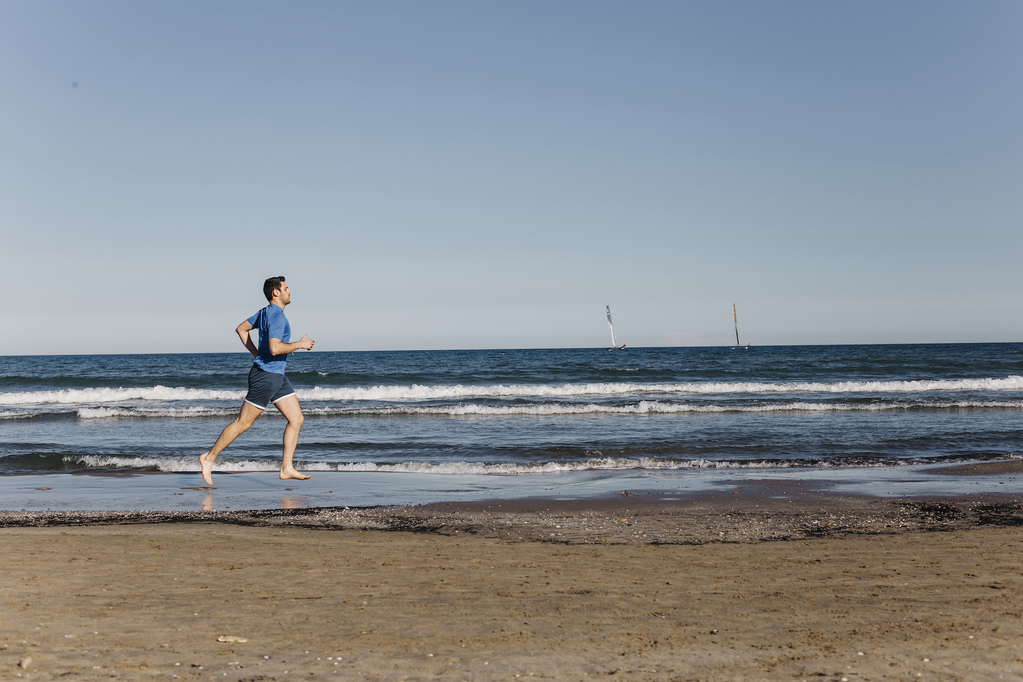 man exercising at the beach