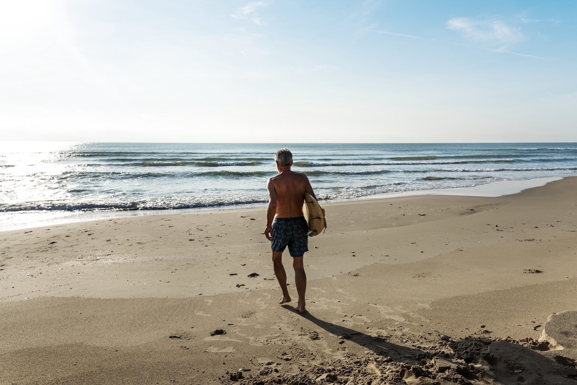 Man going to surf at the beach