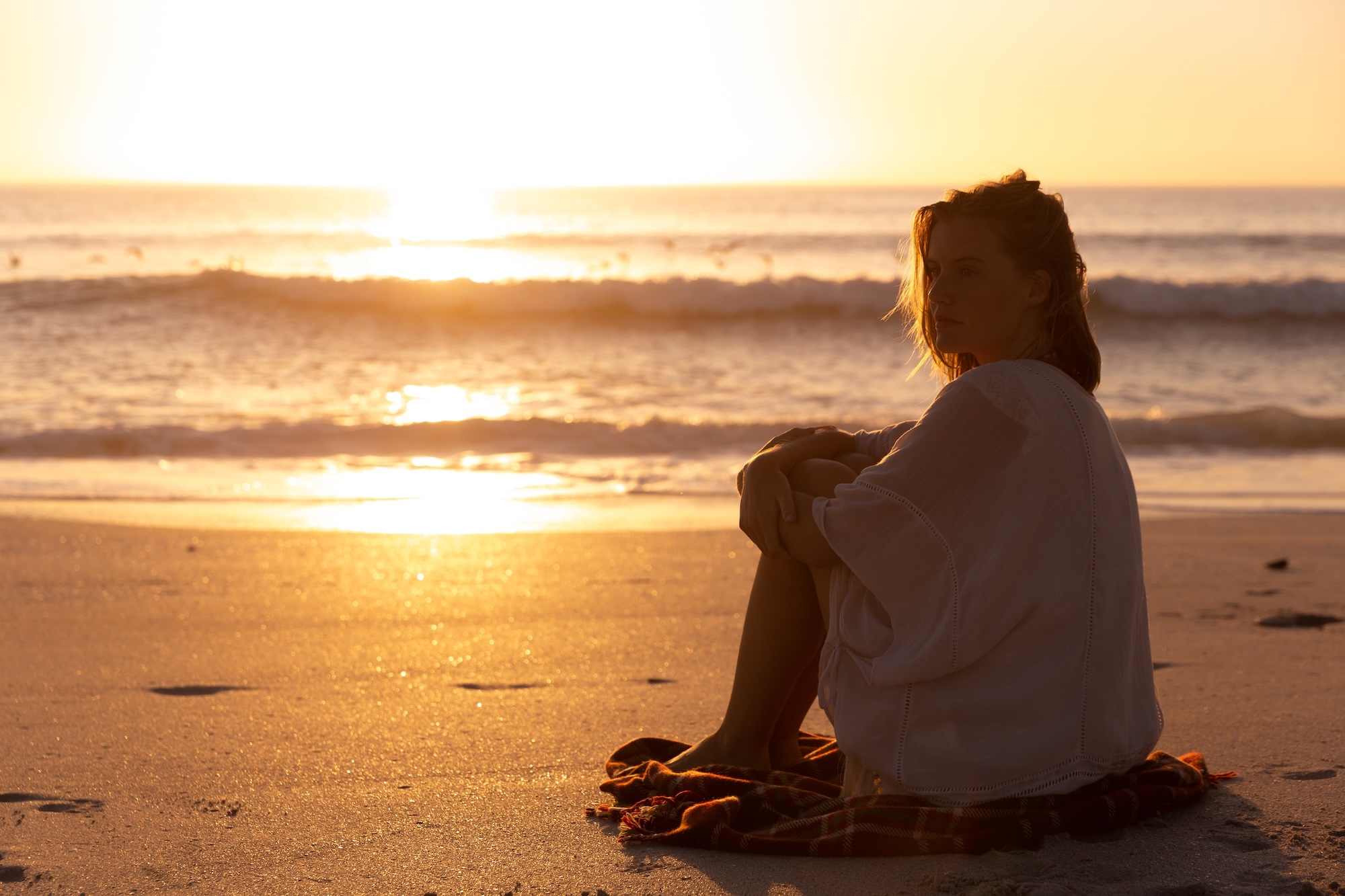 woman on the beach at sunset