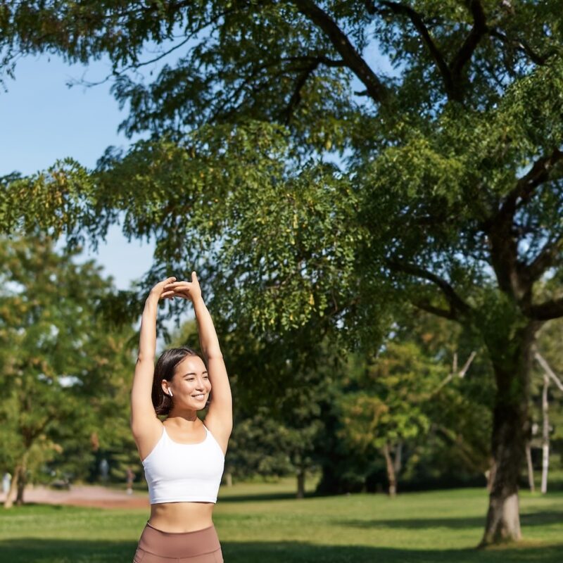 girl smiling while exercising in a park