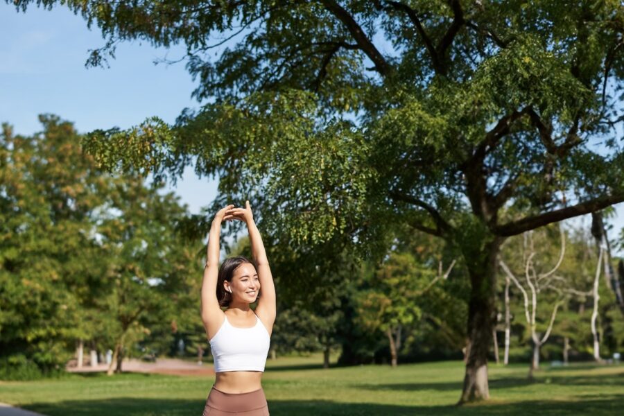 girl smiling while exercising in a park