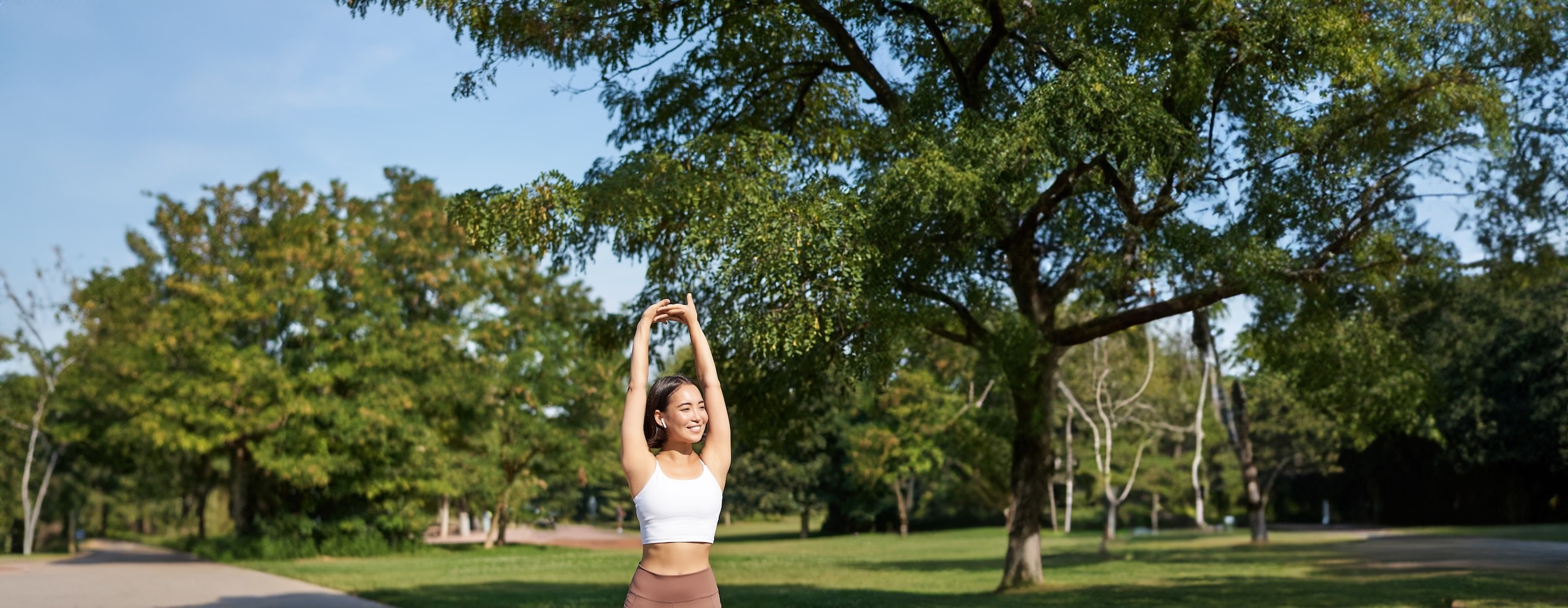 girl smiling while exercising in a park